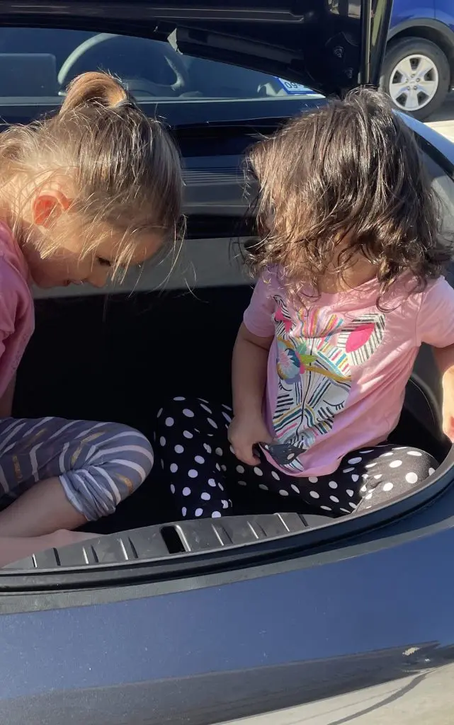 Daughters in Fronk of Tesla Model 3