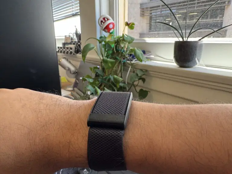 Whopp on my wrist with plants in the background