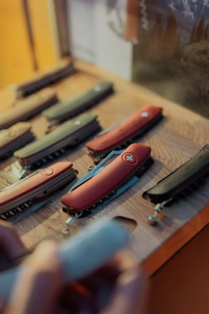 swiss army knives display on wooden table